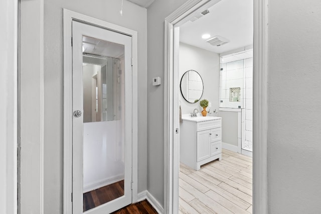 bathroom with hardwood / wood-style flooring and vanity