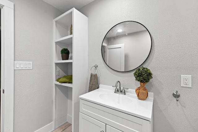 bathroom with vanity and hardwood / wood-style flooring