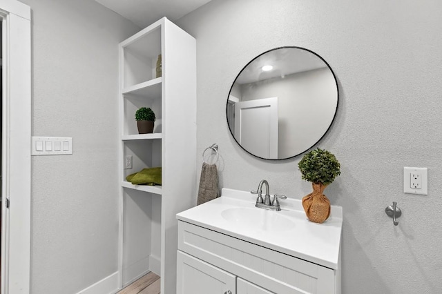 1708 Payne Ave, Austin, TX 78757 - bathroom featuring vanity, baseboards, and wood finished floors