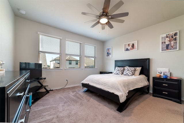 bedroom with light carpet and ceiling fan