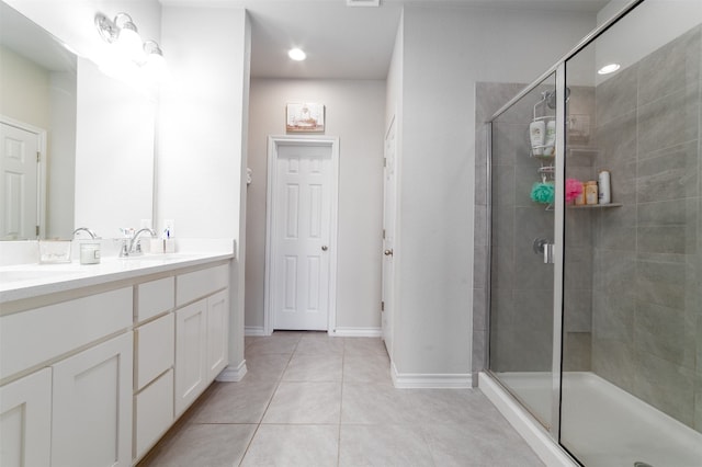 bathroom with tile patterned floors, a shower with shower door, and vanity