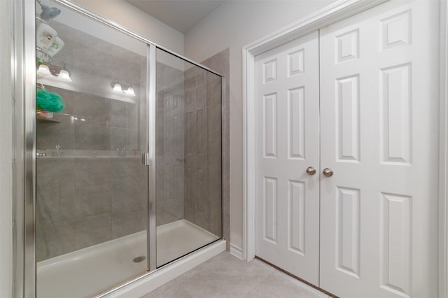 bathroom featuring tile patterned flooring and a shower with door