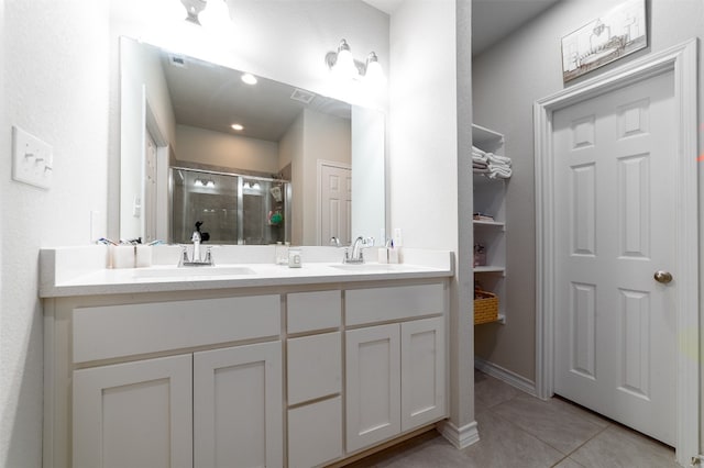 bathroom with vanity, tile patterned flooring, and walk in shower