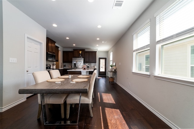 dining room with dark hardwood / wood-style flooring