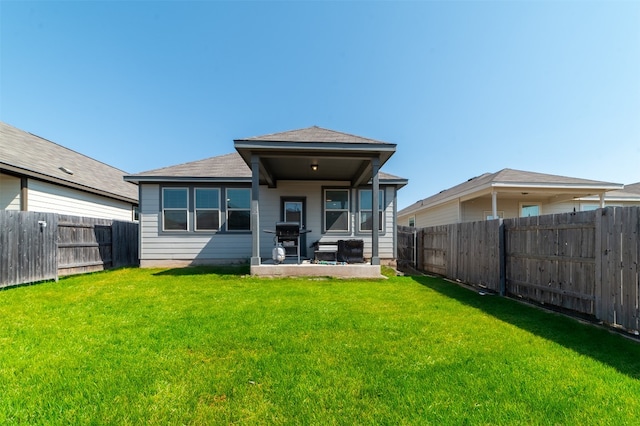 rear view of property featuring a yard