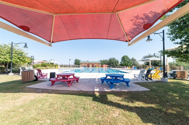 view of pool featuring a yard and a patio area