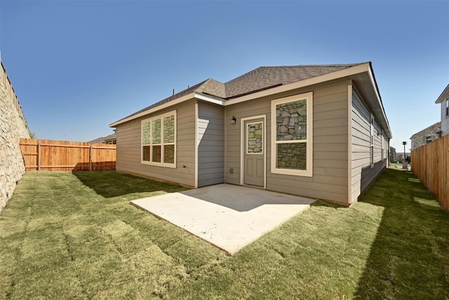 back of house featuring a yard and a patio area