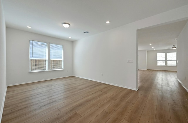 spare room with light hardwood / wood-style flooring and ceiling fan