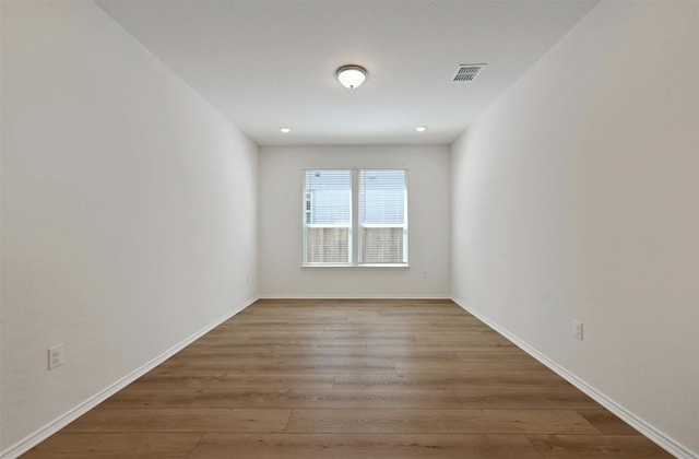 empty room with hardwood / wood-style floors