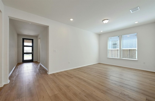 spare room with a healthy amount of sunlight and light hardwood / wood-style floors