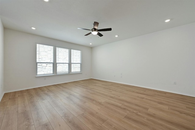 spare room with light hardwood / wood-style flooring and ceiling fan