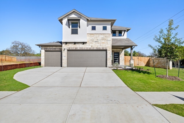 view of front of property featuring a garage and a front yard