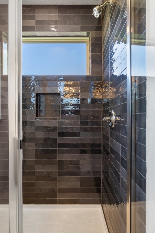 bathroom with tiled shower