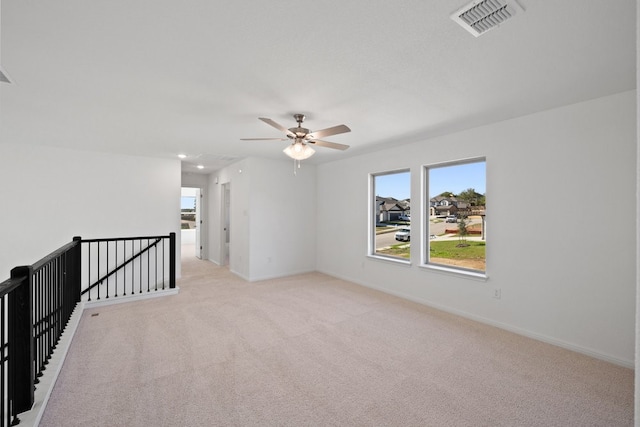 carpeted empty room featuring ceiling fan