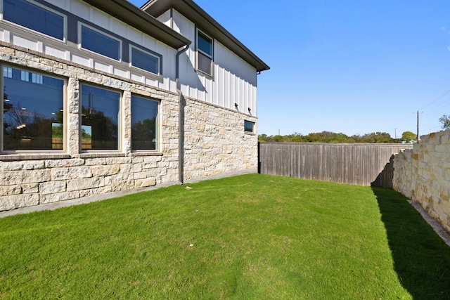 view of side of home featuring a lawn