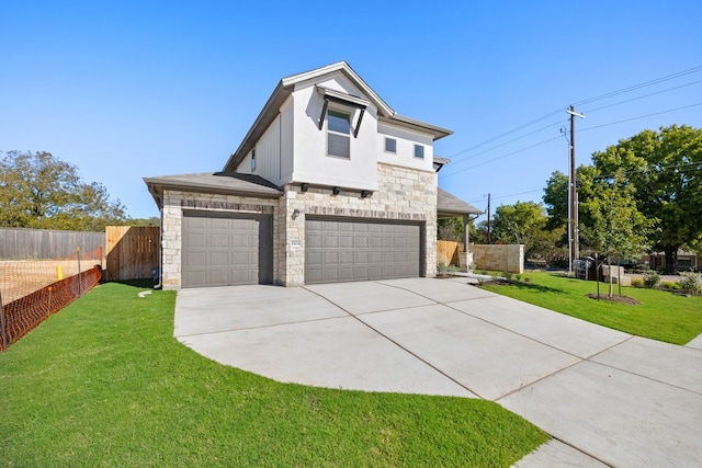 view of front of property featuring a front yard and a garage