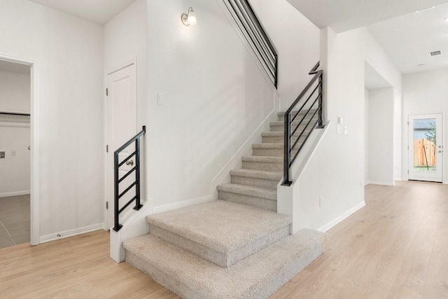 stairs with hardwood / wood-style flooring