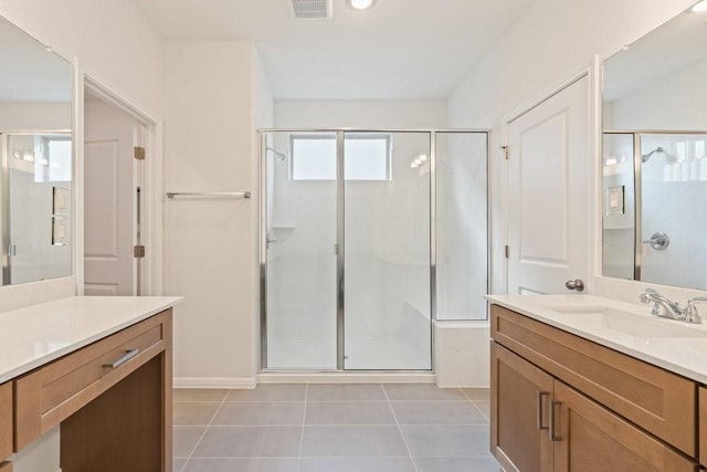 bathroom with tile patterned floors, vanity, and a shower with shower door