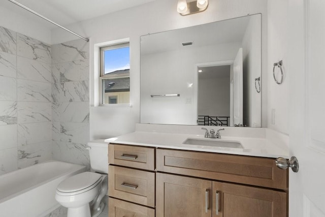 full bathroom featuring vanity, tiled shower / bath combo, and toilet