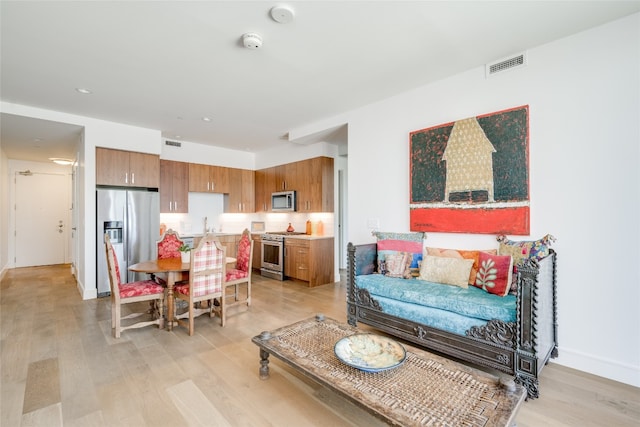 living room with sink and light hardwood / wood-style floors