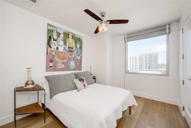 bedroom with light wood-type flooring and ceiling fan