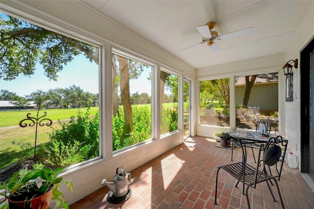 sunroom featuring ceiling fan