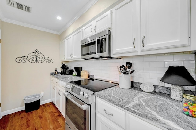 kitchen featuring light stone countertops, appliances with stainless steel finishes, hardwood / wood-style floors, and white cabinetry