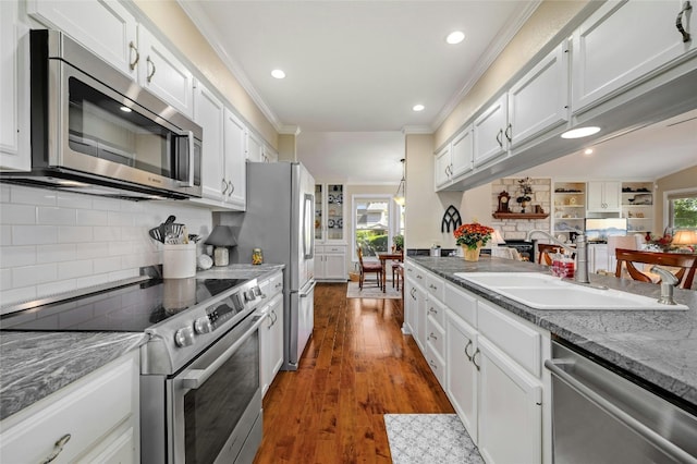 kitchen featuring stainless steel appliances, crown molding, dark hardwood / wood-style flooring, and white cabinetry