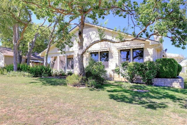 view of front facade featuring a front yard and stone siding