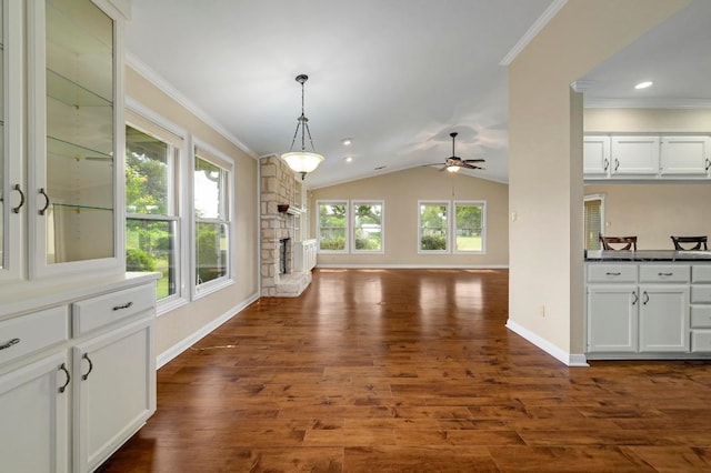 14 Par View Dr, Wimberley, TX 78676 - unfurnished living room featuring a ceiling fan, dark wood-style floors, a fireplace, ornamental molding, and lofted ceiling