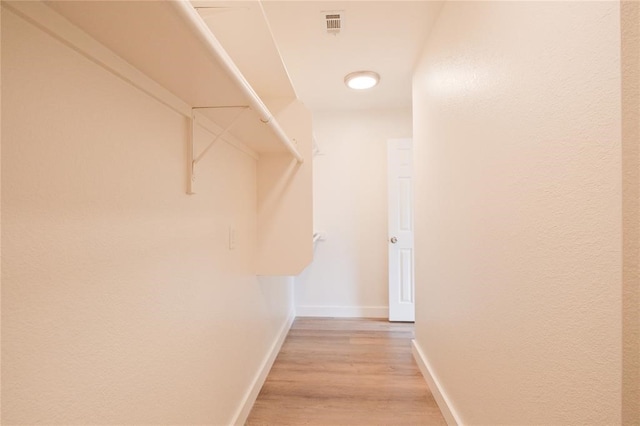 spacious closet with light hardwood / wood-style floors