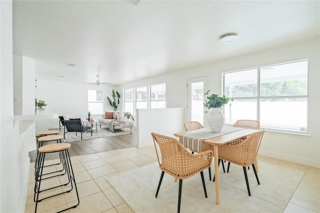 dining area with ceiling fan and light hardwood / wood-style floors