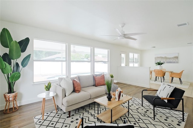 living room with ceiling fan and light hardwood / wood-style floors