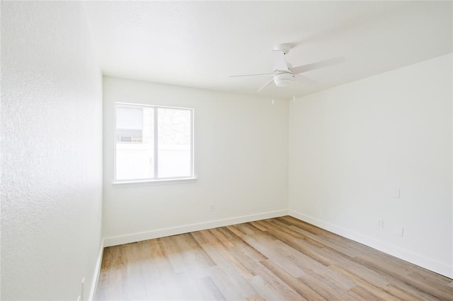 empty room with light hardwood / wood-style floors and ceiling fan