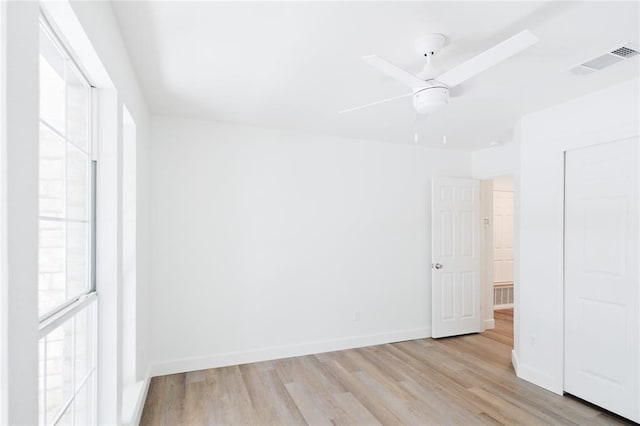 unfurnished room with light wood-type flooring and ceiling fan