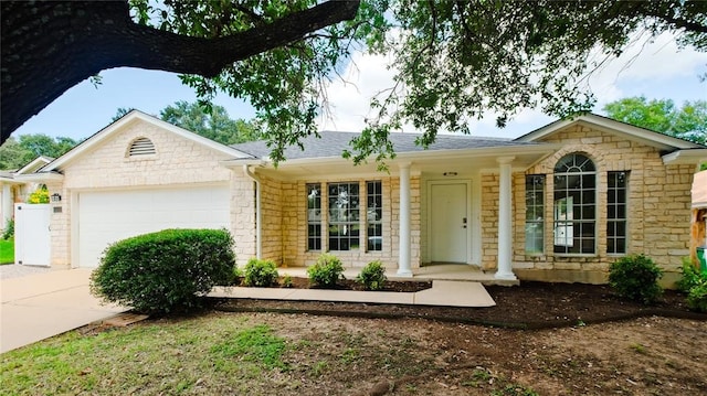 ranch-style home featuring a garage and covered porch