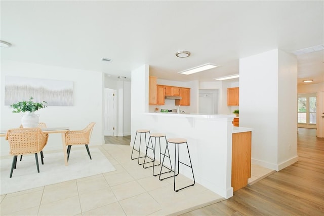 kitchen featuring light hardwood / wood-style floors and kitchen peninsula