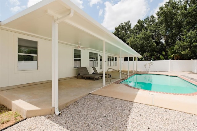 view of swimming pool with ceiling fan and a patio area