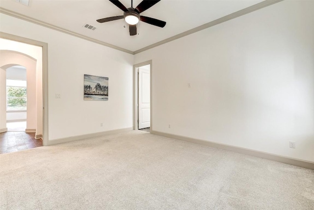 carpeted empty room with ornamental molding and ceiling fan