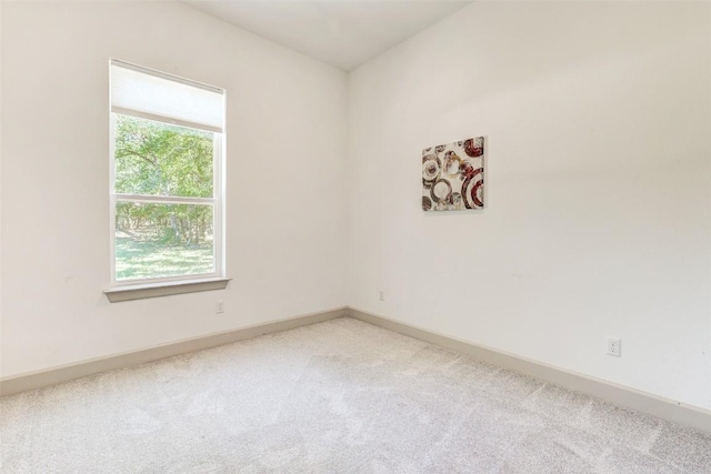 empty room with light carpet and baseboards