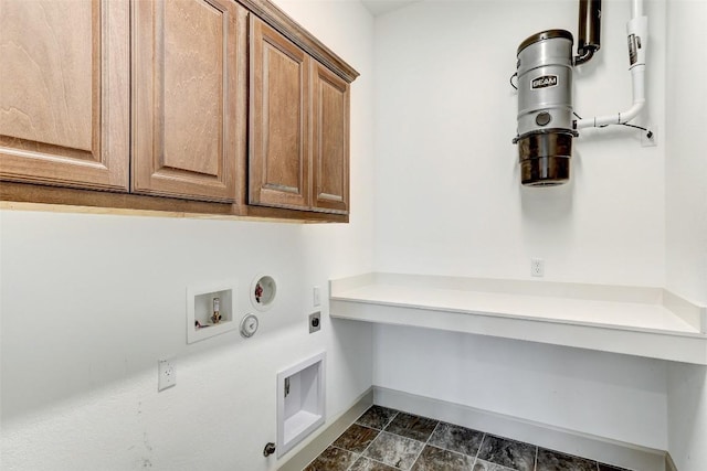 laundry room with hookup for a washing machine, cabinet space, hookup for an electric dryer, gas dryer hookup, and baseboards