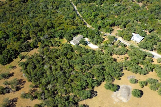 bird's eye view featuring a wooded view