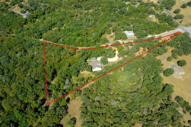 birds eye view of property with a wooded view