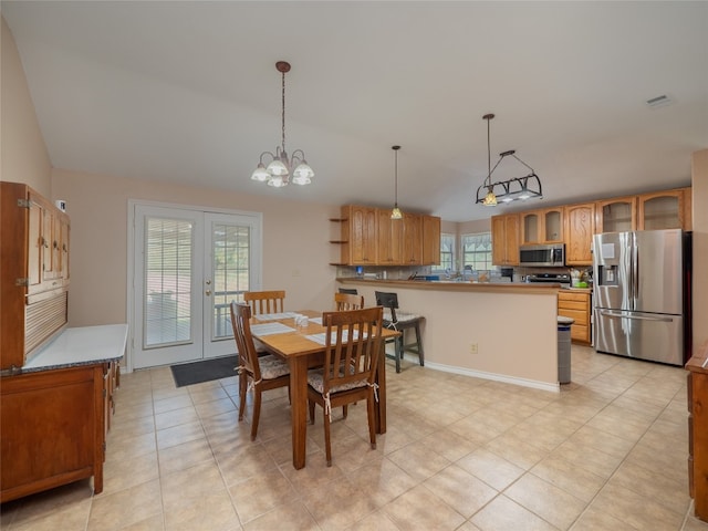 dining space with french doors, light tile patterned flooring, and a notable chandelier