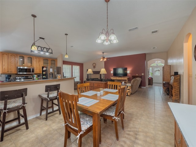 tiled dining area featuring ceiling fan with notable chandelier