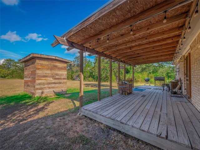 wooden terrace with a lawn