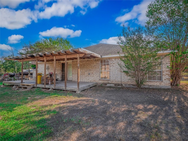 rear view of property featuring a deck and a pergola