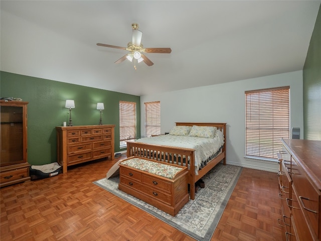 bedroom featuring light parquet flooring, multiple windows, and ceiling fan