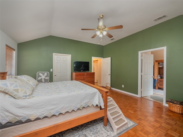 bedroom featuring parquet floors, vaulted ceiling, and ceiling fan