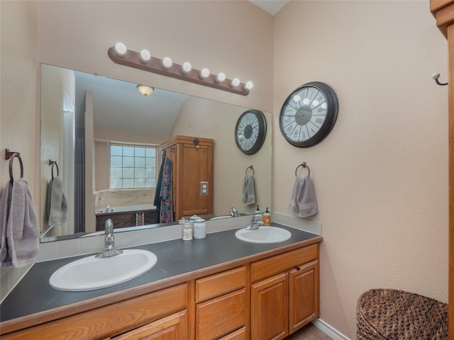 bathroom featuring vanity and lofted ceiling